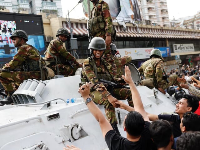 people shake hands with army personnel as they celebrate the resignation of bangladeshi prime minister sheikh hasina in dhaka bangladesh august 5 2024 photo reuters